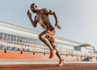 Sprinter mid-stride on a running track