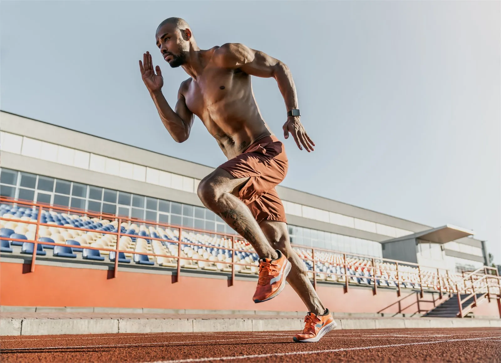 Sprinter mid-stride on a running track
