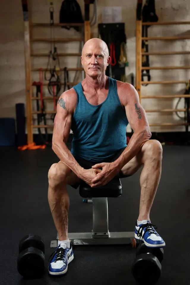 Man seated in a gym between training sets