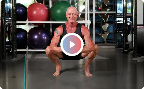 Eric North in a deep squat in a gym